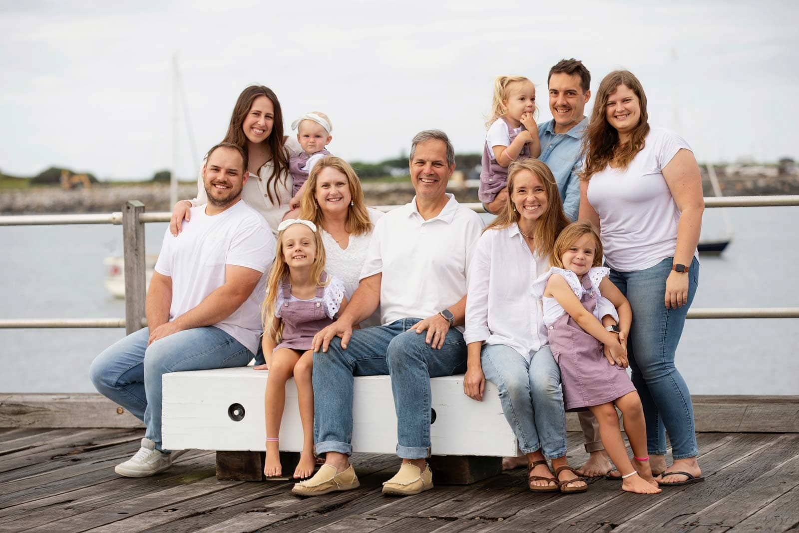 Image of Debbie's family, seated on a timber jetty